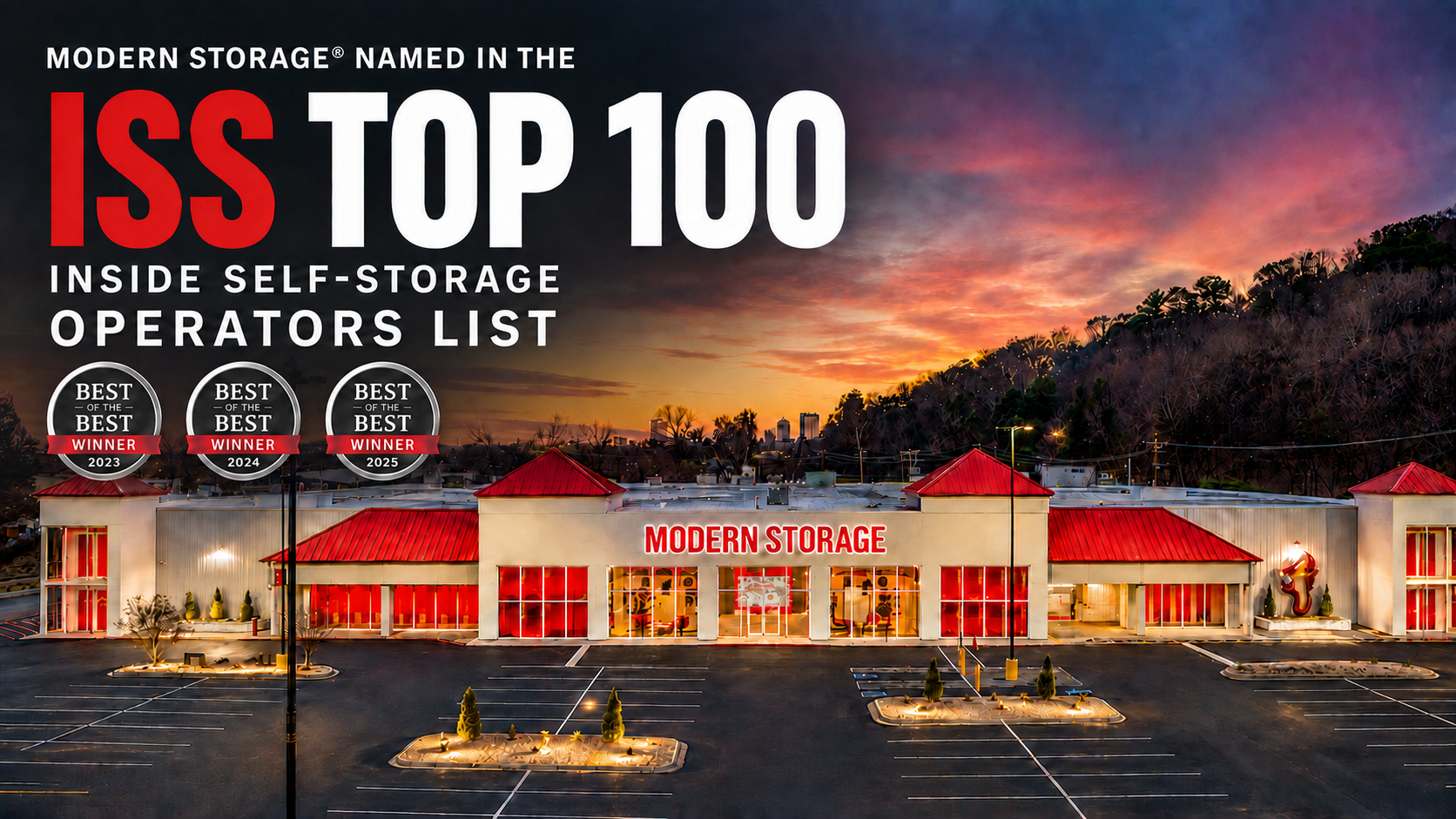 Modern Storage facility illuminated at sunset with red doors and Modern Storage signage